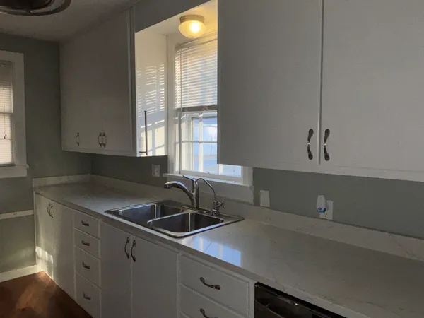 a kitchen with a sink and cabinets