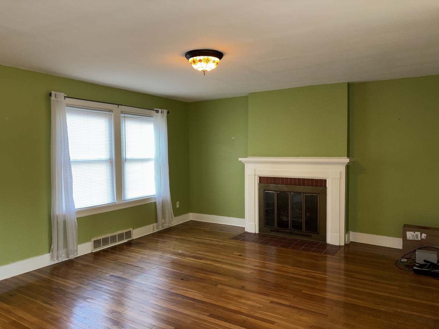 500 South Green Street Anna, IL 62906 - Photo 21 of 30 an empty room with wooden floor fireplace and windows