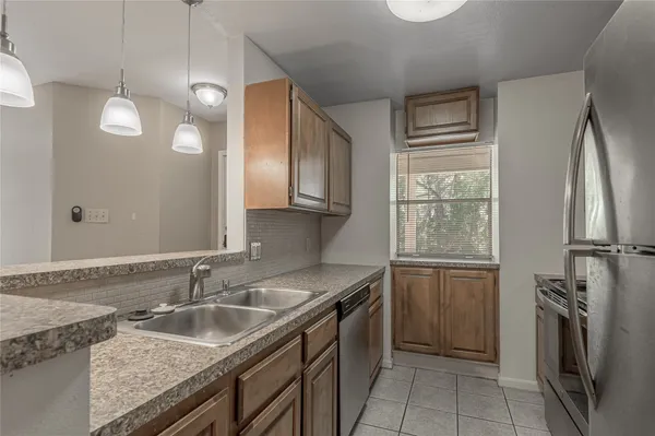 a kitchen with a sink stove and refrigerator