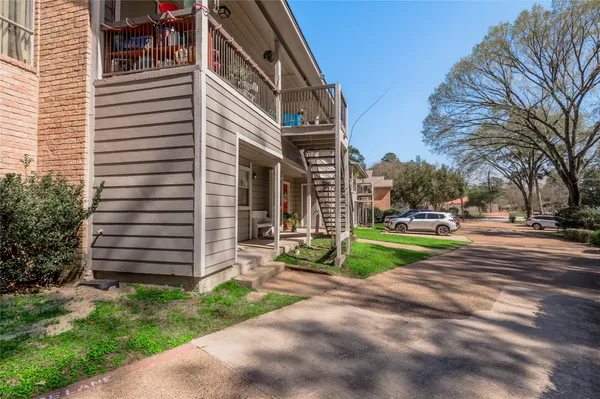 a view of a park with pathway and a building