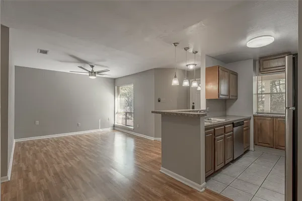 a view of a kitchen with a stove cabinets and wooden floor