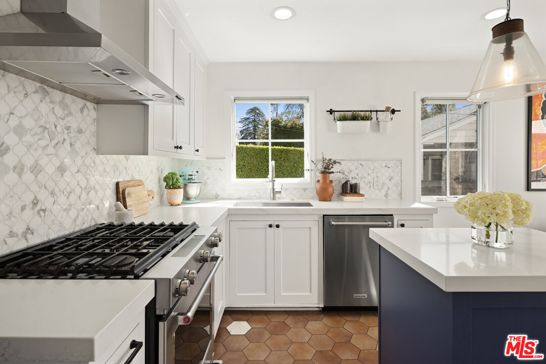 3320 Community Avenue Glendale, CA 91214 - Photo 12 of 32 a kitchen with a sink stove and cabinets