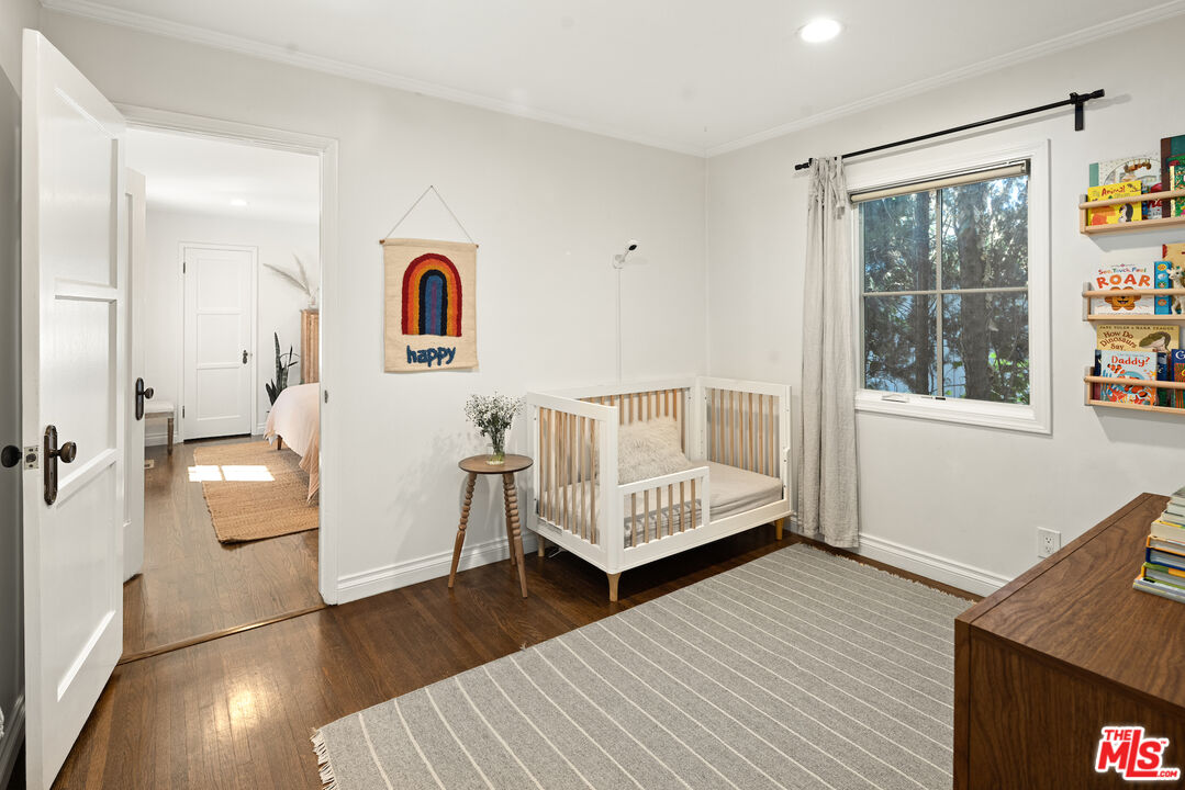 3320 Community Avenue Glendale, CA 91214 - Photo 16 of 32 a view of a bedroom with wooden floor and window