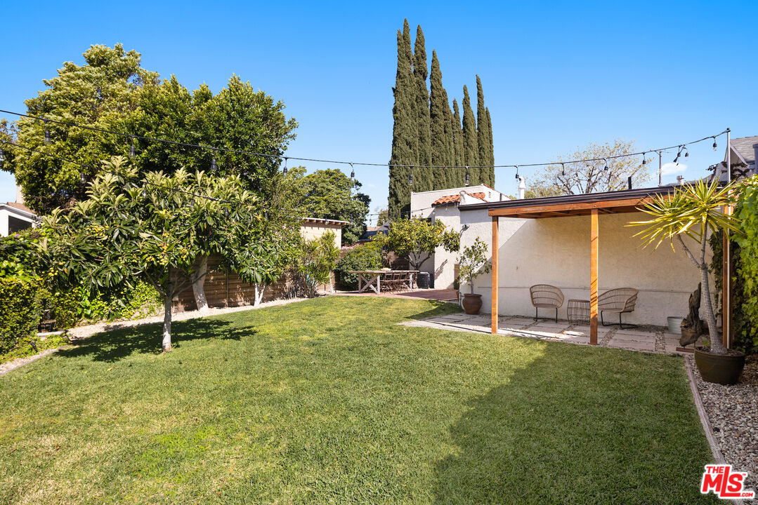 3320 Community Avenue Glendale, CA 91214 - Photo 21 of 32 a view of a backyard with table and chairs and potted plants