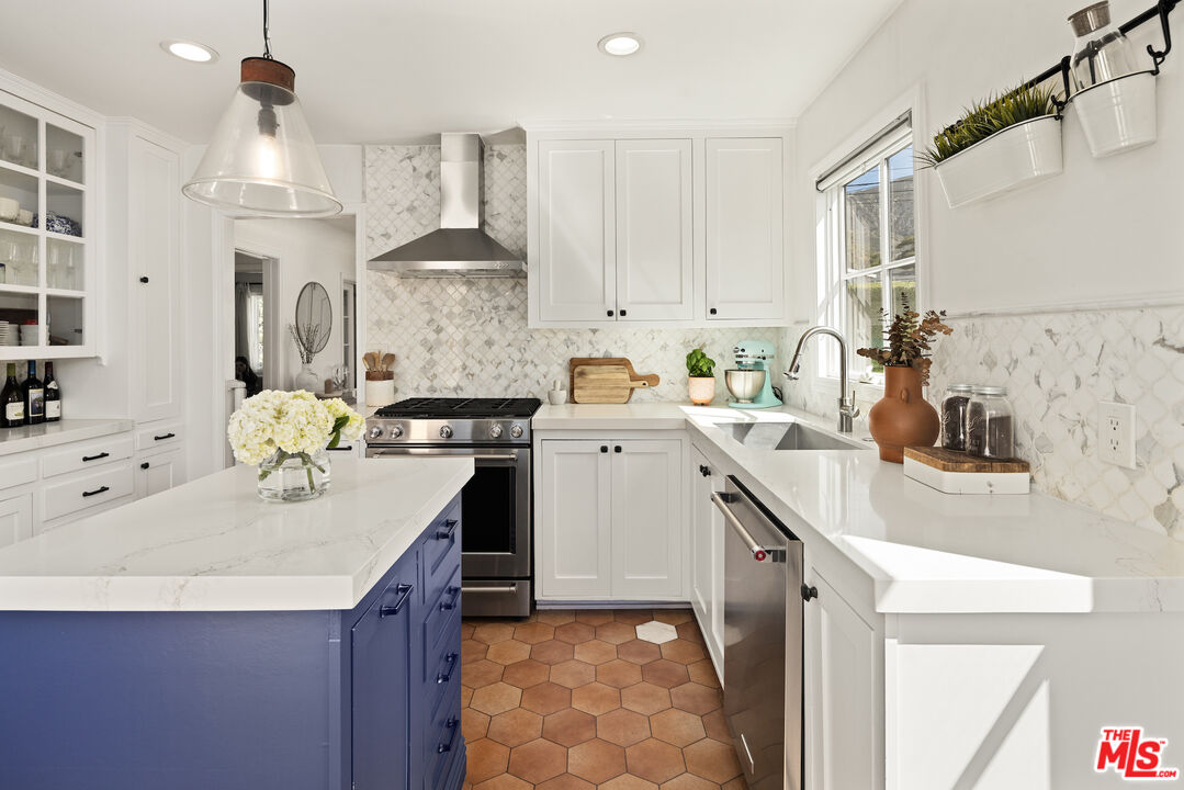 3320 Community Avenue Glendale, CA 91214 - Photo 10 of 32 a kitchen with a sink a stove and cabinets