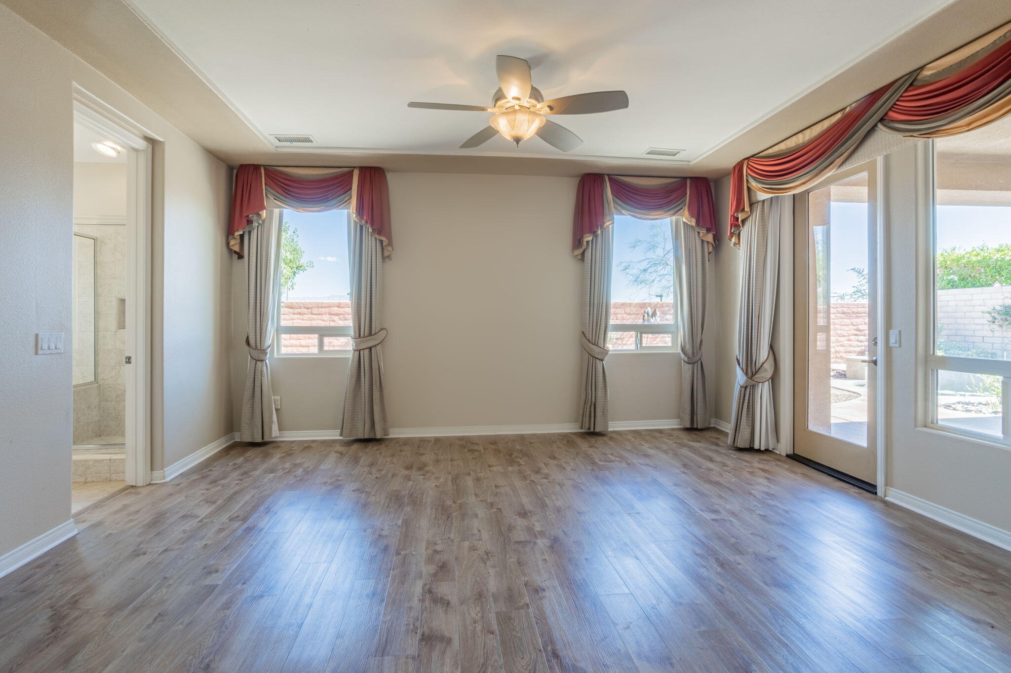 244 Via Padua Rancho Mirage, CA 92270 - Photo 11 of 30 an empty room with wooden floor and windows