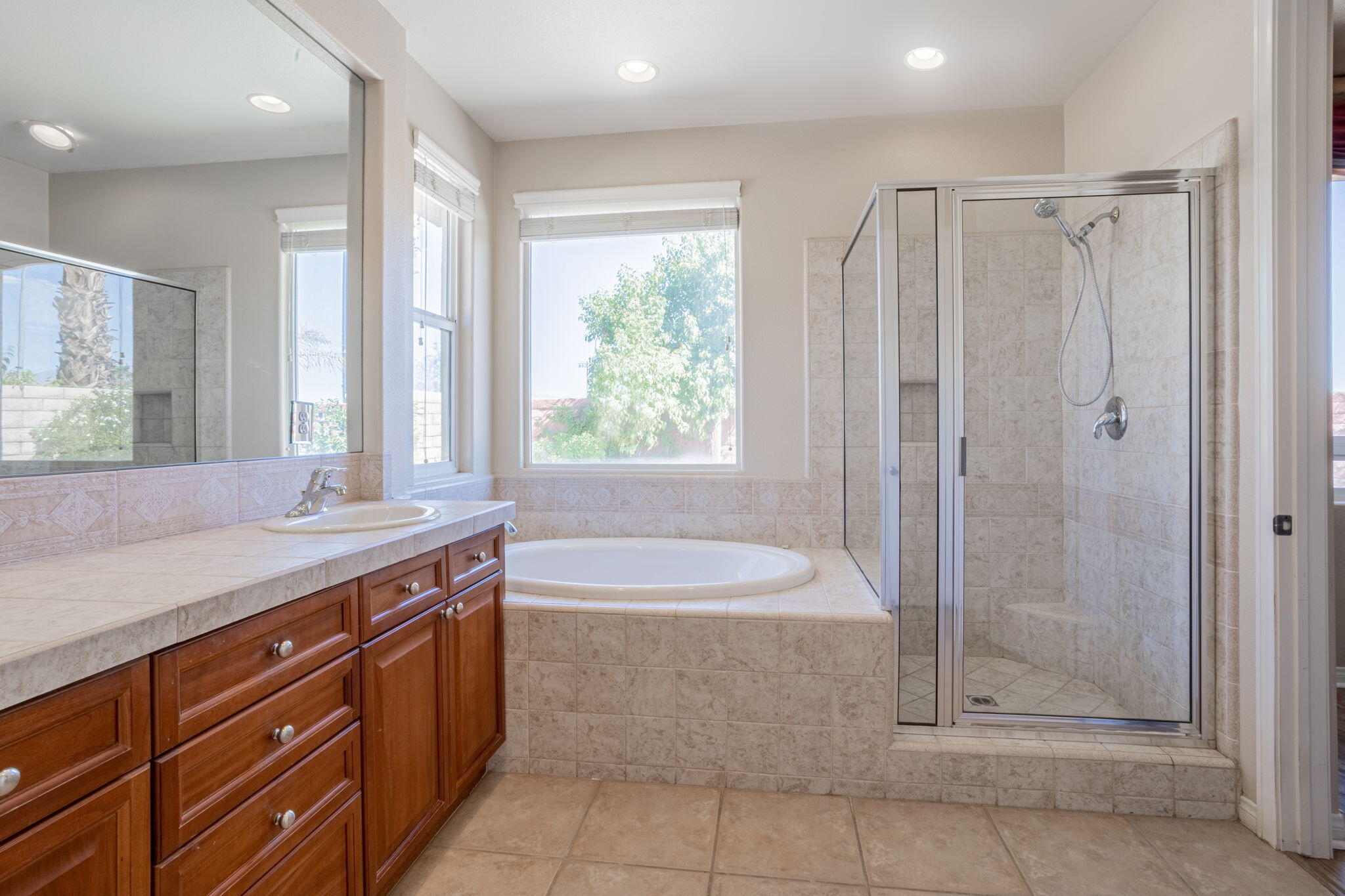 244 Via Padua Rancho Mirage, CA 92270 - Photo 12 of 30 a spacious bathroom with a shower sink and mirror