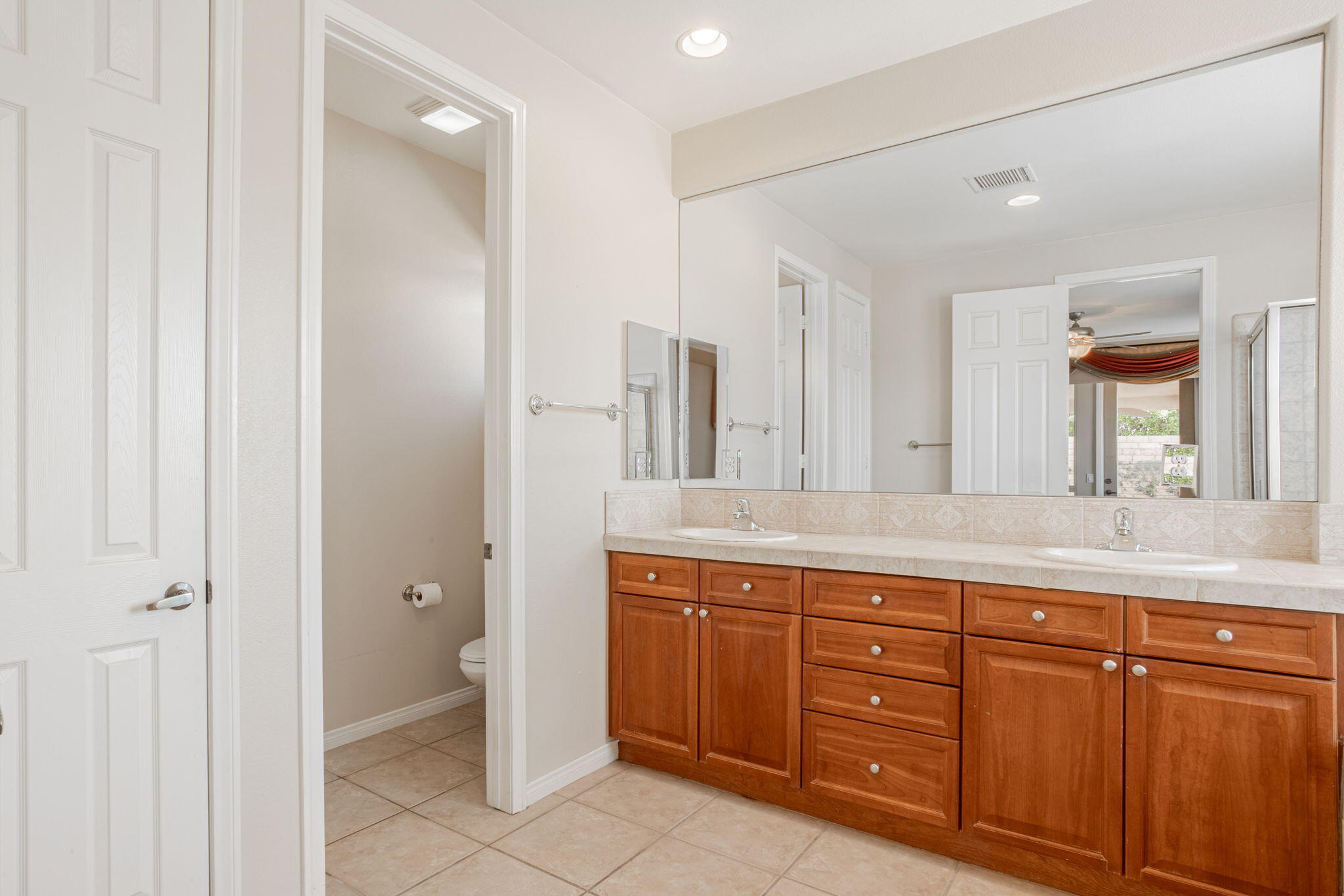 244 Via Padua Rancho Mirage, CA 92270 - Photo 13 of 30 a spacious bathroom with a granite countertop sink a mirror and a