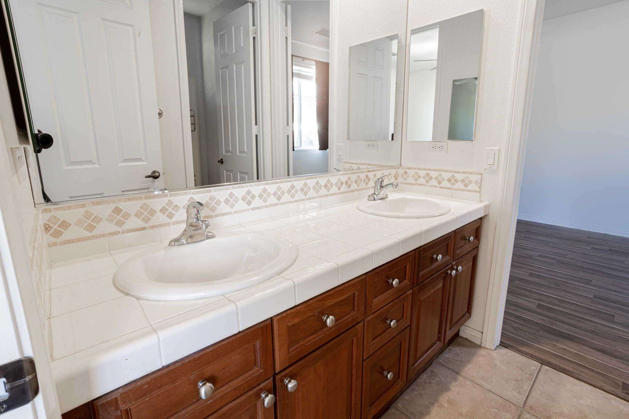 244 Via Padua Rancho Mirage, CA 92270 - Photo 16 of 30 a bathroom with a double vanity sink and a mirror