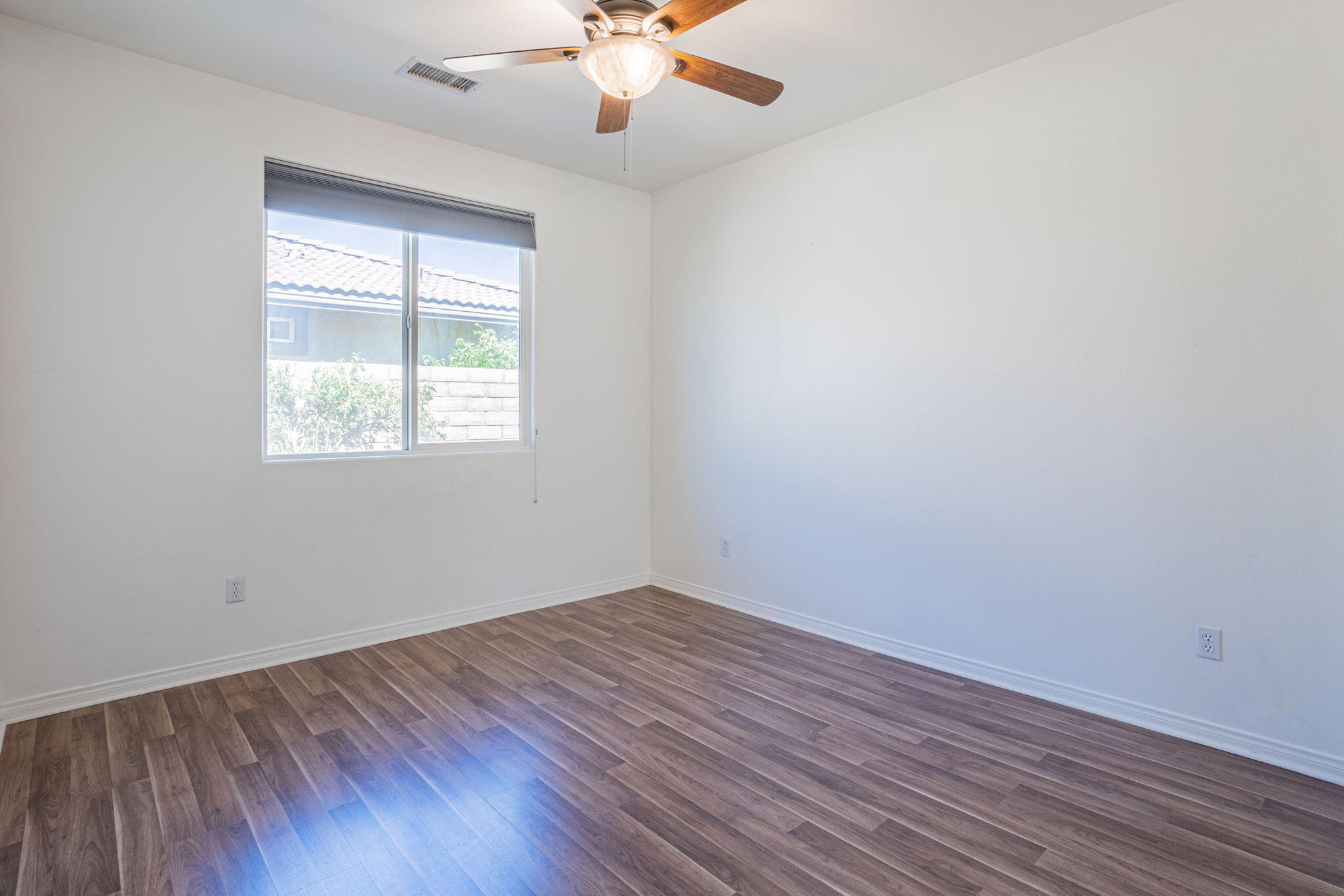 244 Via Padua Rancho Mirage, CA 92270 - Photo 18 of 30 an empty room with a window and wooden floor