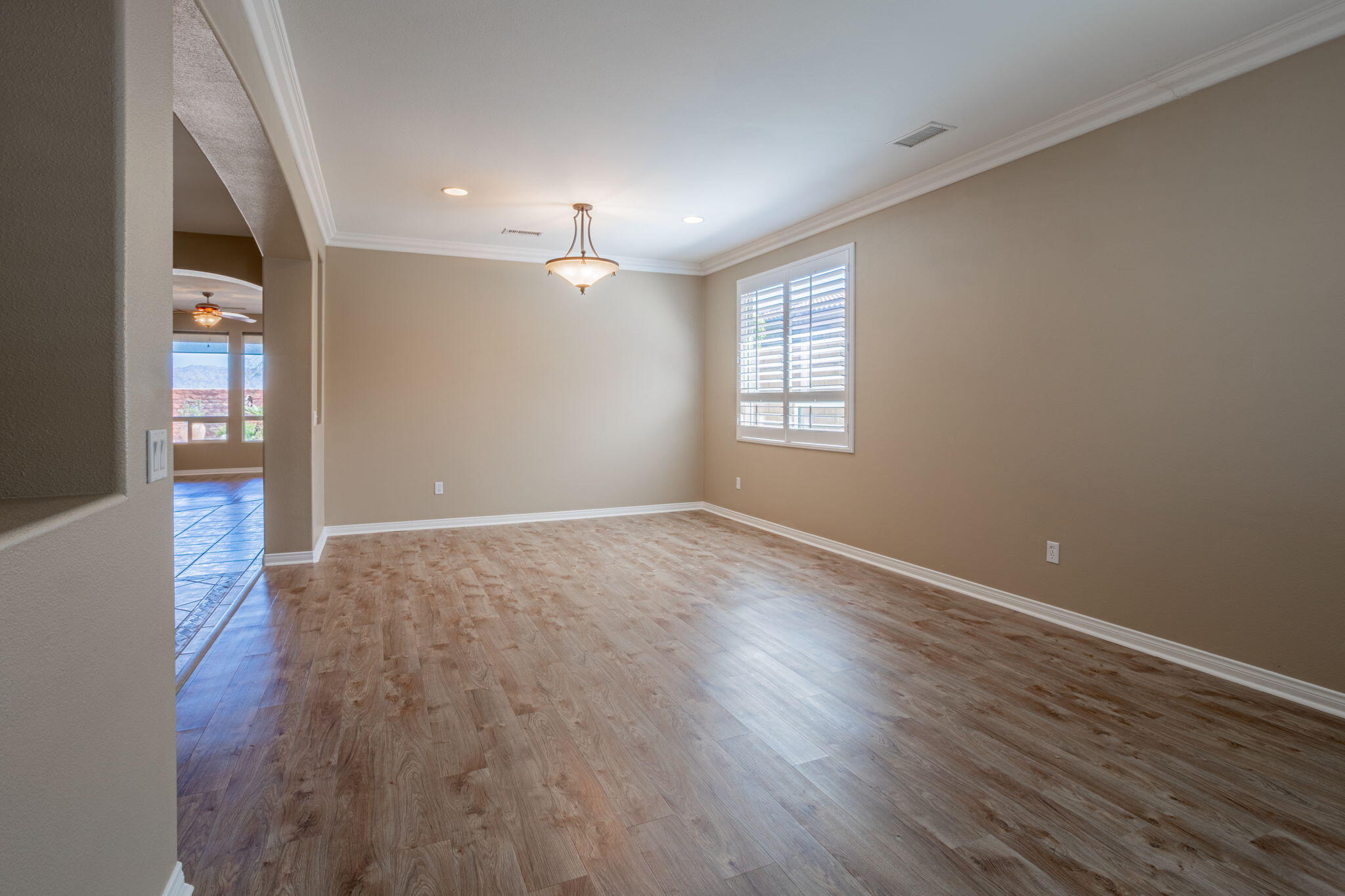 244 Via Padua Rancho Mirage, CA 92270 - Photo 4 of 30 an empty room with wooden floor and windows