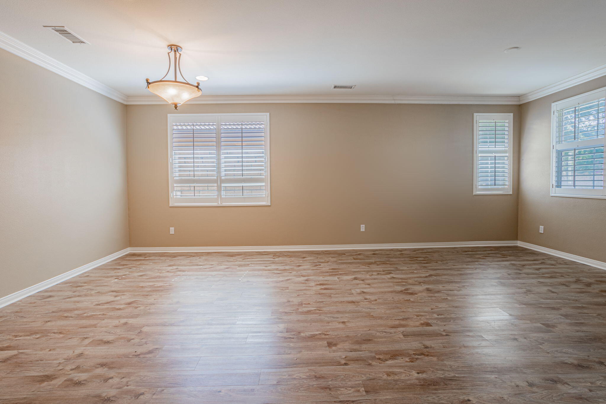 244 Via Padua Rancho Mirage, CA 92270 - Photo 5 of 30 an empty room with wooden floor and windows