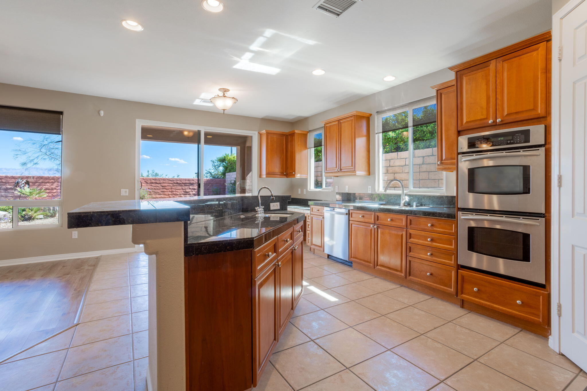 244 Via Padua Rancho Mirage, CA 92270 - Photo 7 of 30 a kitchen with stainless steel appliances granite countertop a sink and cabinets
