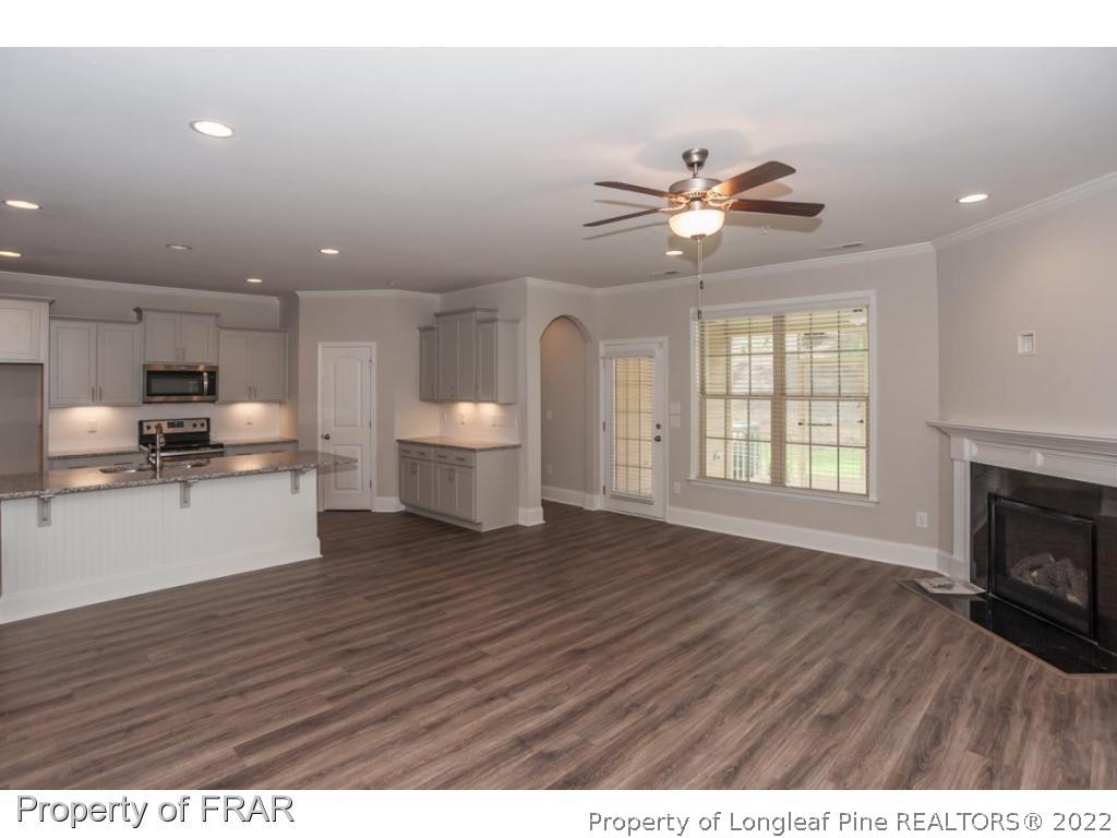 160 Winged Foot Road Pinehurst, NC 28374 - Photo 13 of 35 a view of an empty room with window and wooden floor
