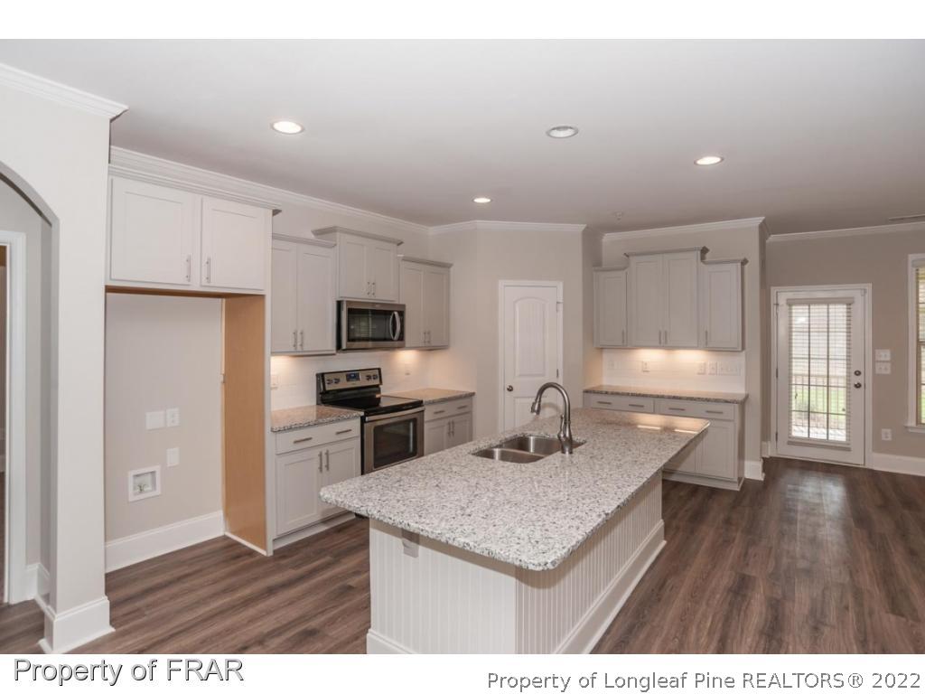 160 Winged Foot Road Pinehurst, NC 28374 - Photo 17 of 35 a kitchen with refrigerator cabinets and wooden floor