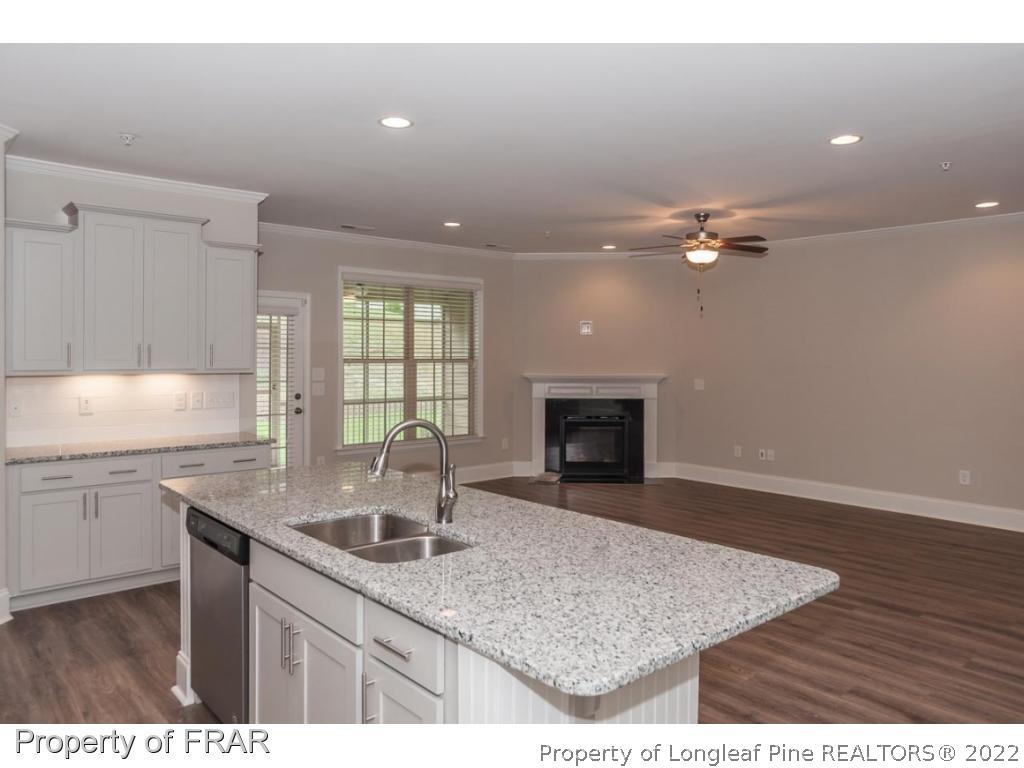 160 Winged Foot Road Pinehurst, NC 28374 - Photo 20 of 35 a kitchen with sink cabinets and chandelier