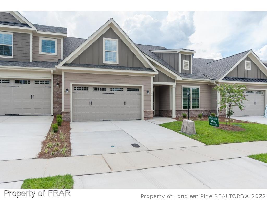 160 Winged Foot Road Pinehurst, NC 28374 - Photo 2 of 35 a front view of a house with a yard and garage