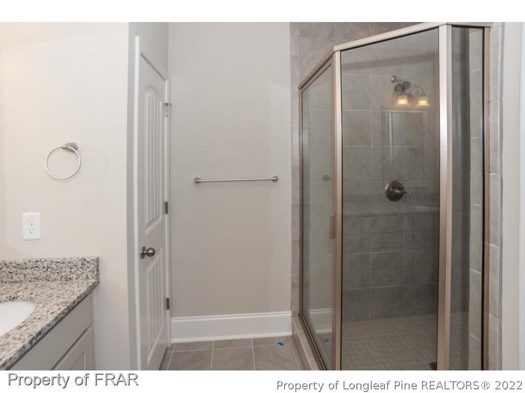 160 Winged Foot Road Pinehurst, NC 28374 - Photo 25 of 35 a bathroom with a shower and a sink