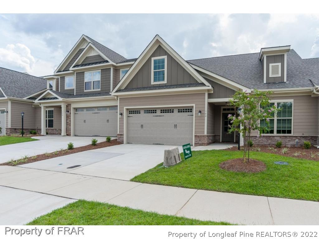 160 Winged Foot Road Pinehurst, NC 28374 - Photo 3 of 35 a front view of a house with a yard and garage
