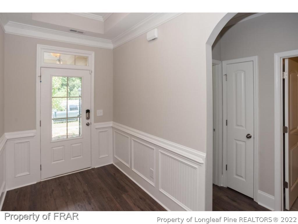 160 Winged Foot Road Pinehurst, NC 28374 - Photo 10 of 35 a view of an empty room with wooden floor and a window