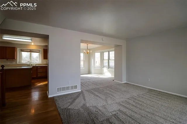 a view of an empty room and glass door