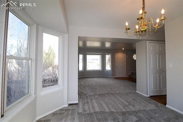 a kitchen with granite countertop a sink stove and refrigerator
