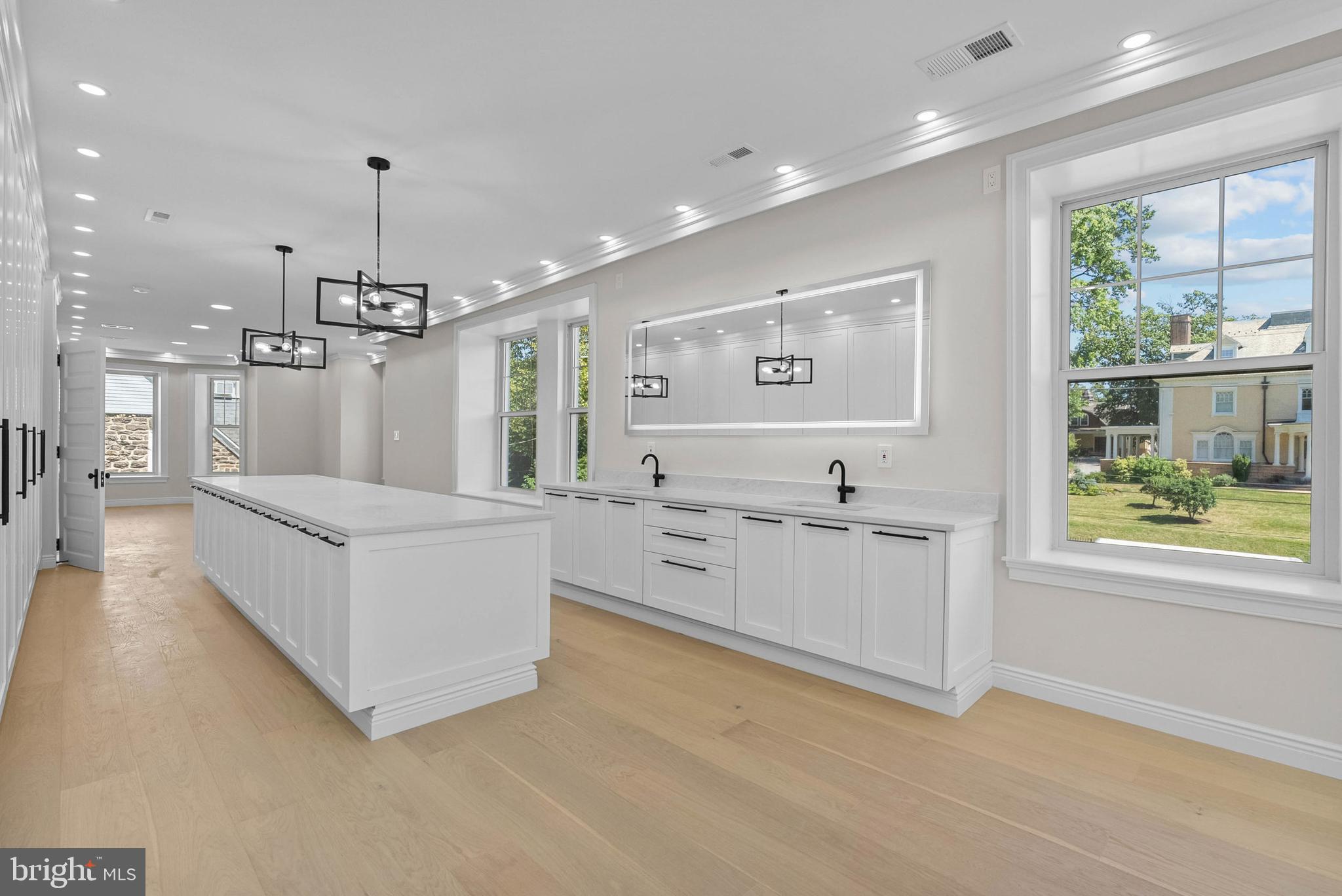 319 Pelham Road Philadelphia, PA 19119 - Photo 21 of 40 a large white kitchen with a large window a sink and stainless steel appliances