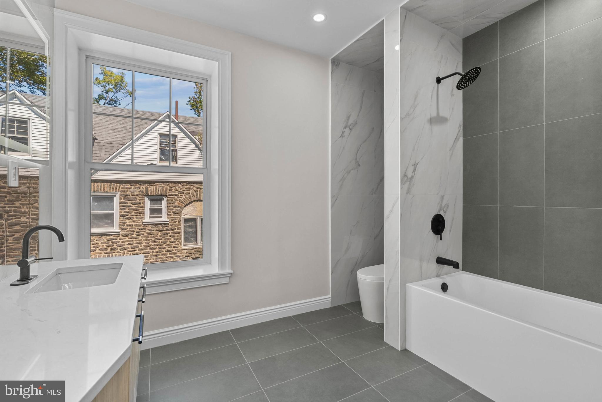 319 Pelham Road Philadelphia, PA 19119 - Photo 26 of 40 a bathroom with a tub sink and mirror