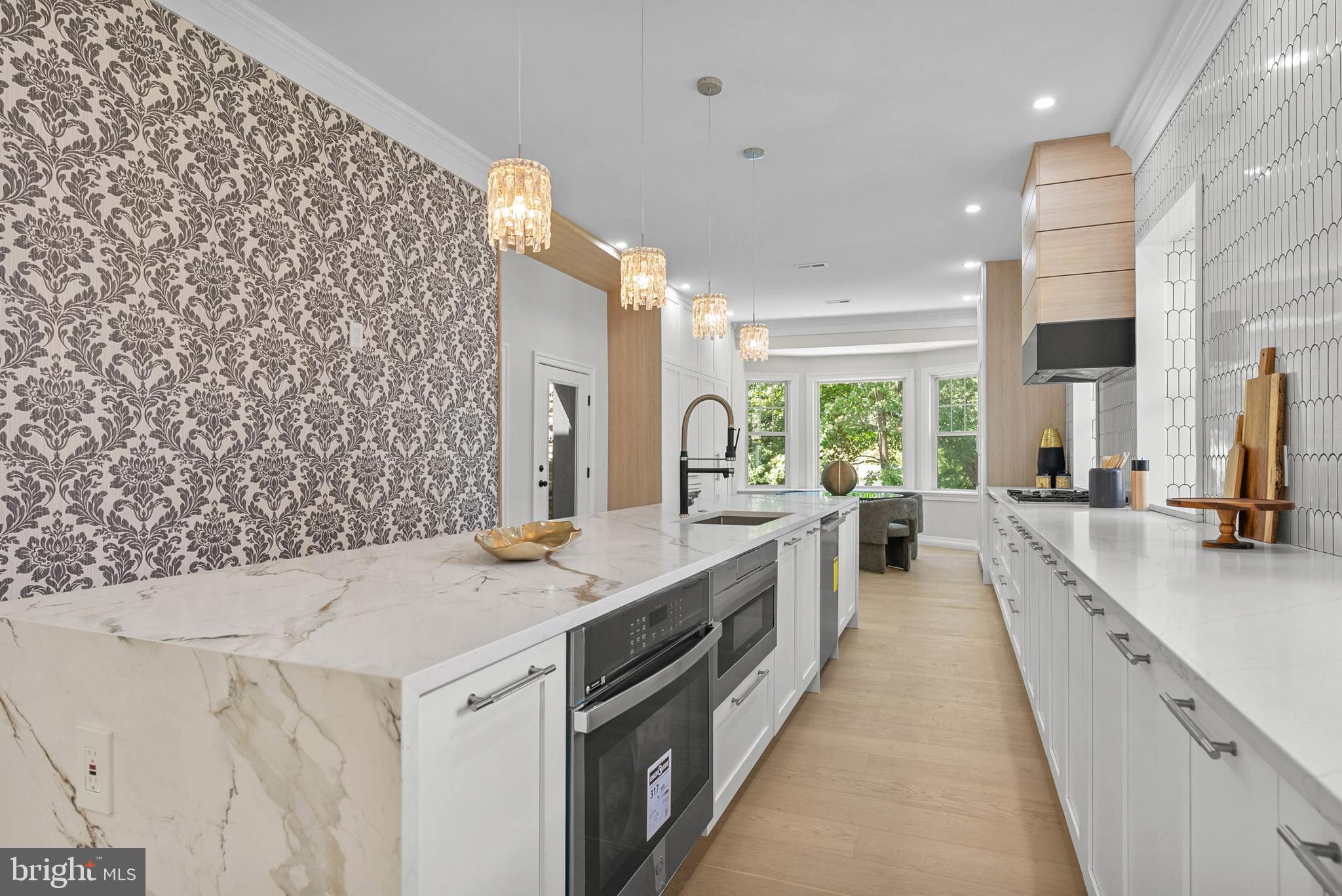 319 Pelham Road Philadelphia, PA 19119 - Photo 3 of 40 a large kitchen with kitchen island a sink stove and a large window
