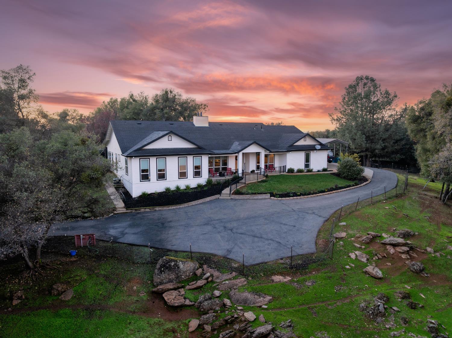 a view of house with garden space and car parked
