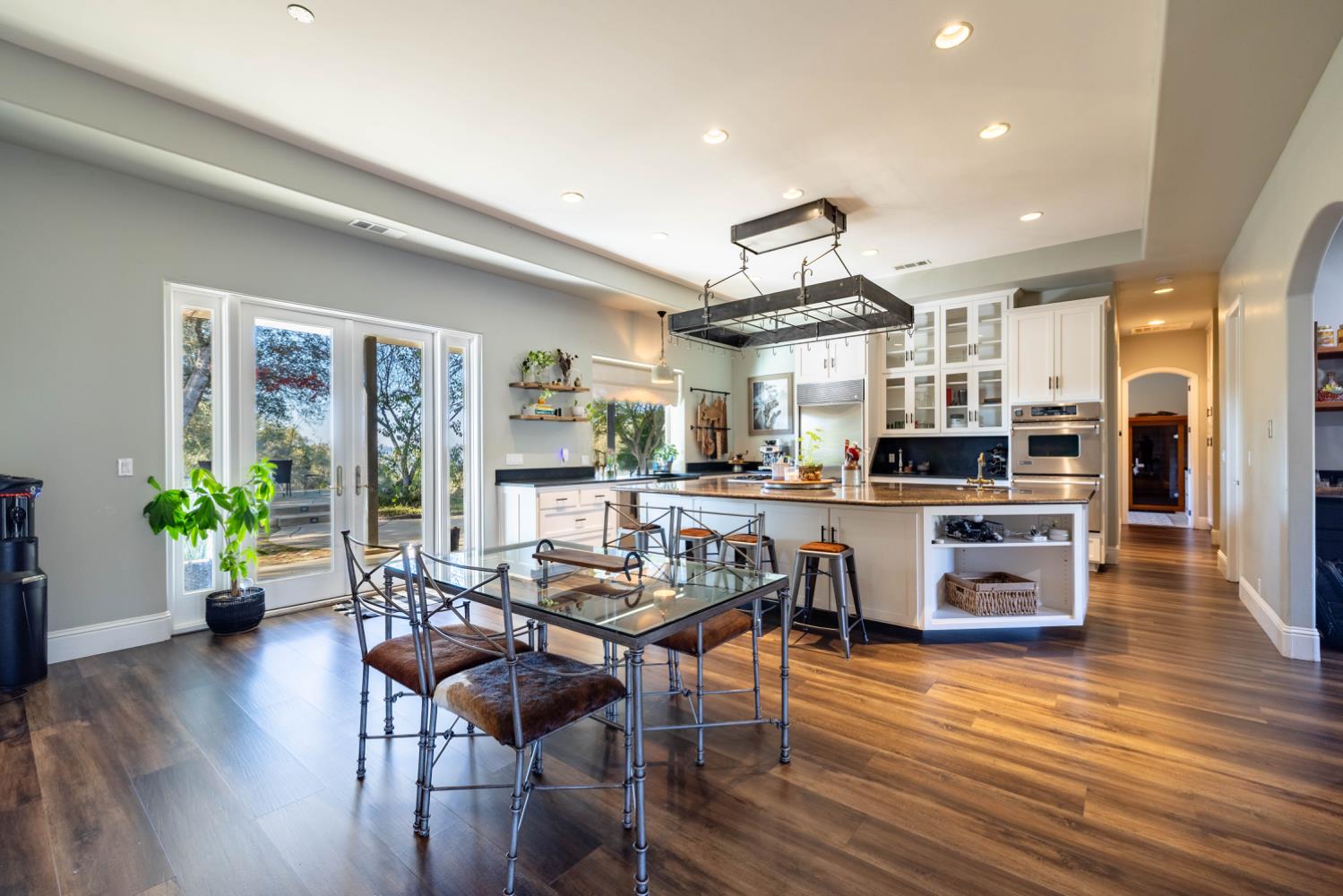 5840 China Hill Road El Dorado, CA 95623 - Photo 12 of 84 a kitchen with stainless steel appliances wooden floor dining table and chairs