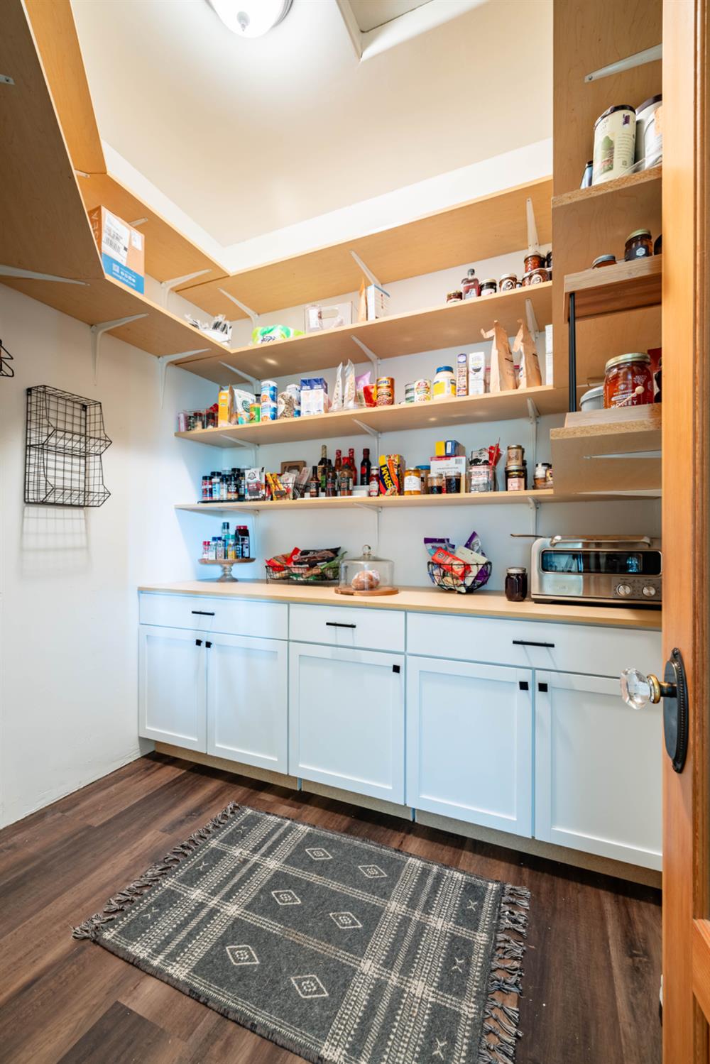 5840 China Hill Road El Dorado, CA 95623 - Photo 22 of 84 a kitchen with cabinets and wooden floor