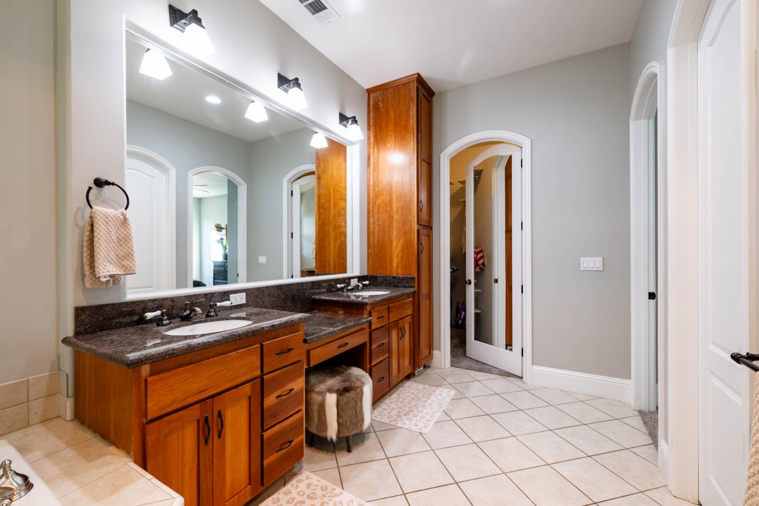 5840 China Hill Road El Dorado, CA 95623 - Photo 36 of 84 a spacious bathroom with a granite countertop sink and a mirror