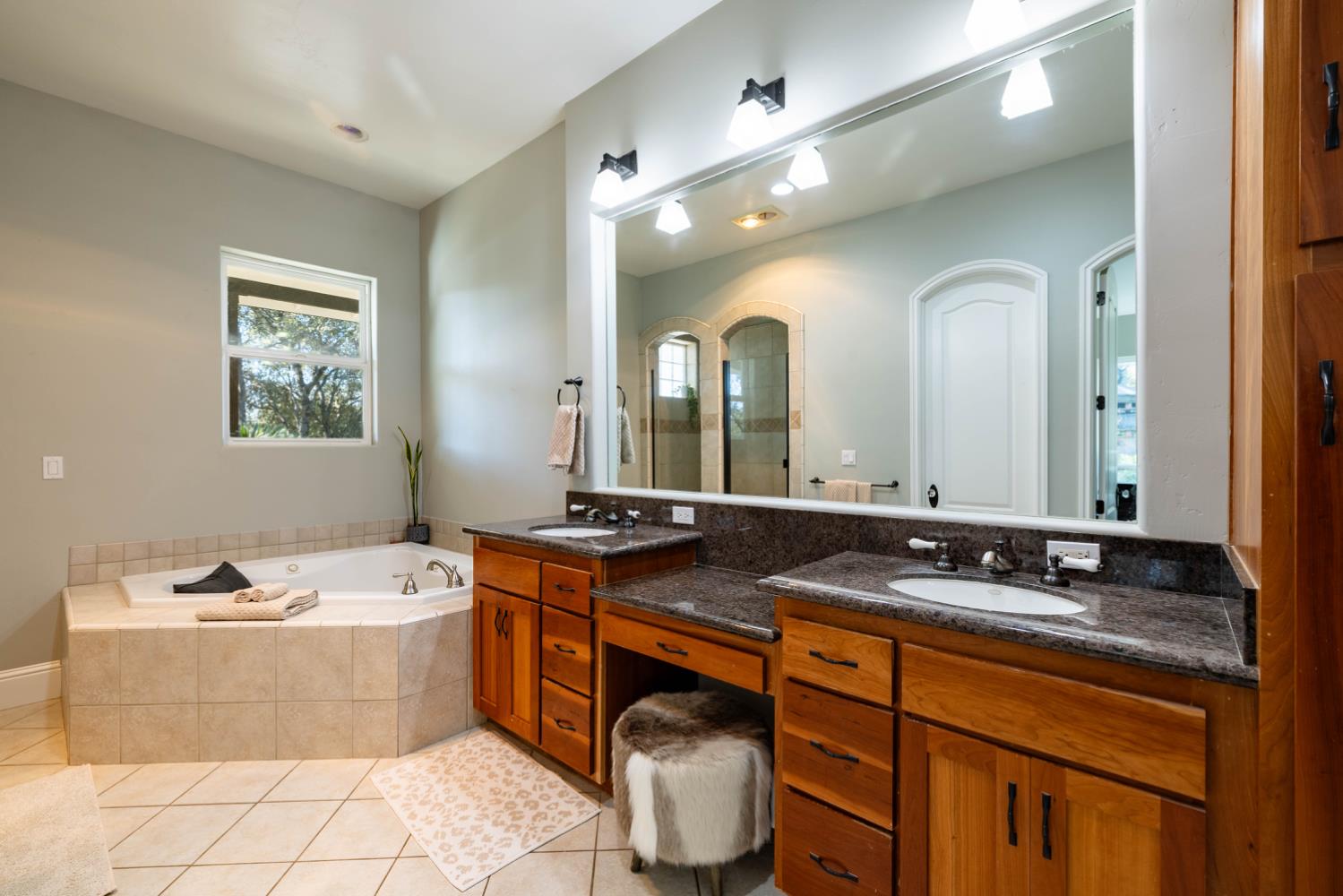5840 China Hill Road El Dorado, CA 95623 - Photo 37 of 84 a spacious bathroom with a granite countertop double vanity sink a mirror and bathtub