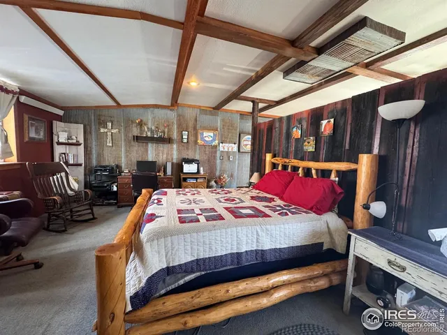 a bedroom with bed and wooden floors