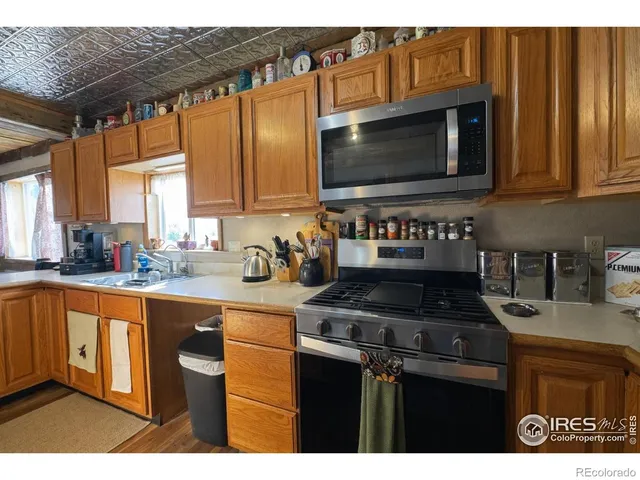 a kitchen with granite countertop a sink and a stove top oven