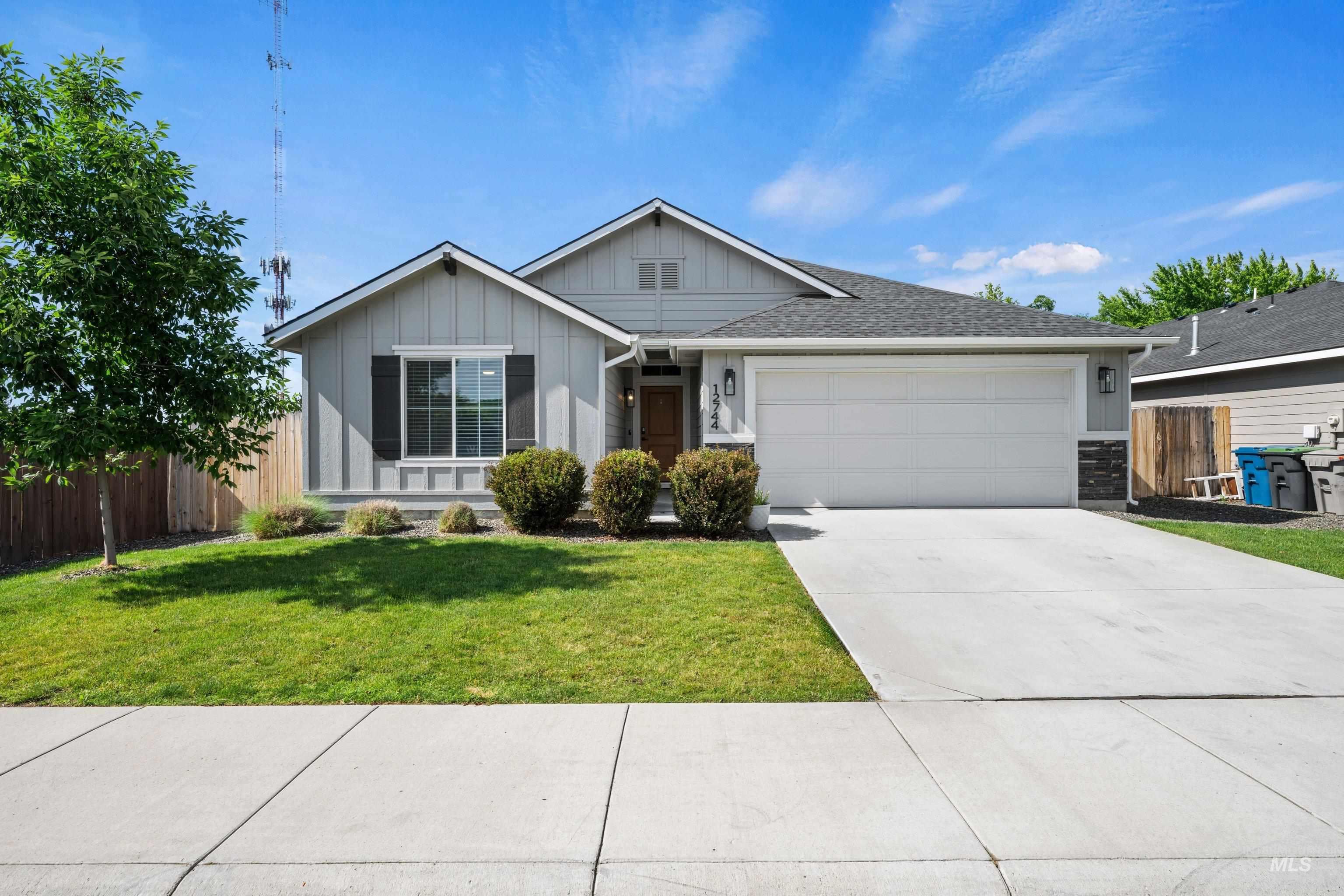 12744 West Fig Street Boise, ID 83713 - Photo 2 of 34 Single-story residence featuring gray vertical siding and a stone-accented facade