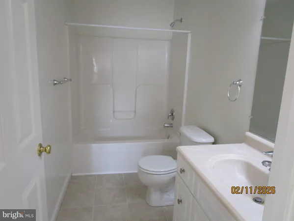 a white toilet sitting next to a bathroom sink and a shower