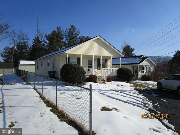 a front view of a house with yard and balcony