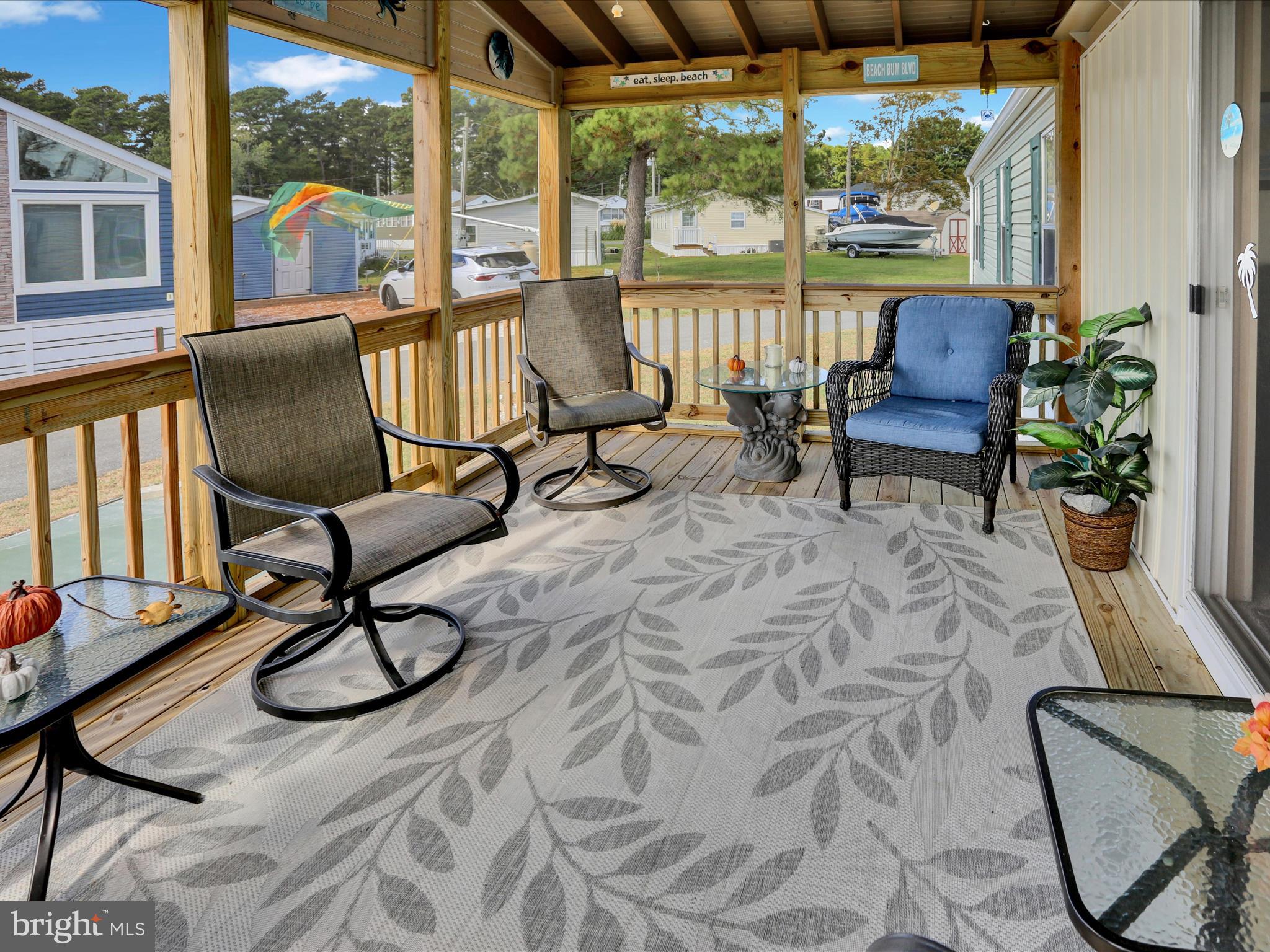 27412 Grove Circle Road Millsboro, DE 19966 - Photo 12 of 43 a living room with furniture and floor to ceiling windows