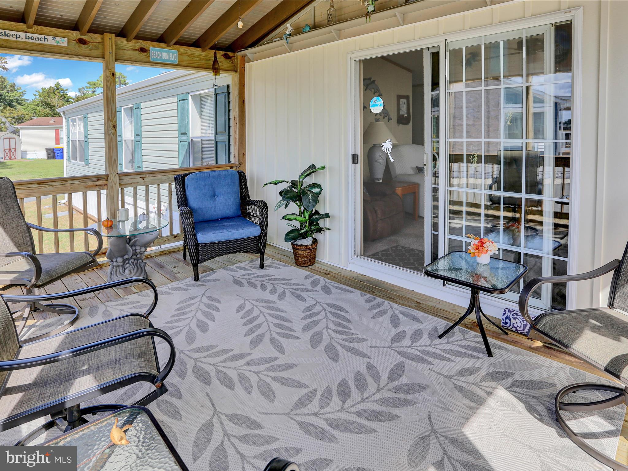 27412 Grove Circle Road Millsboro, DE 19966 - Photo 13 of 43 a living room with patio furniture and a window