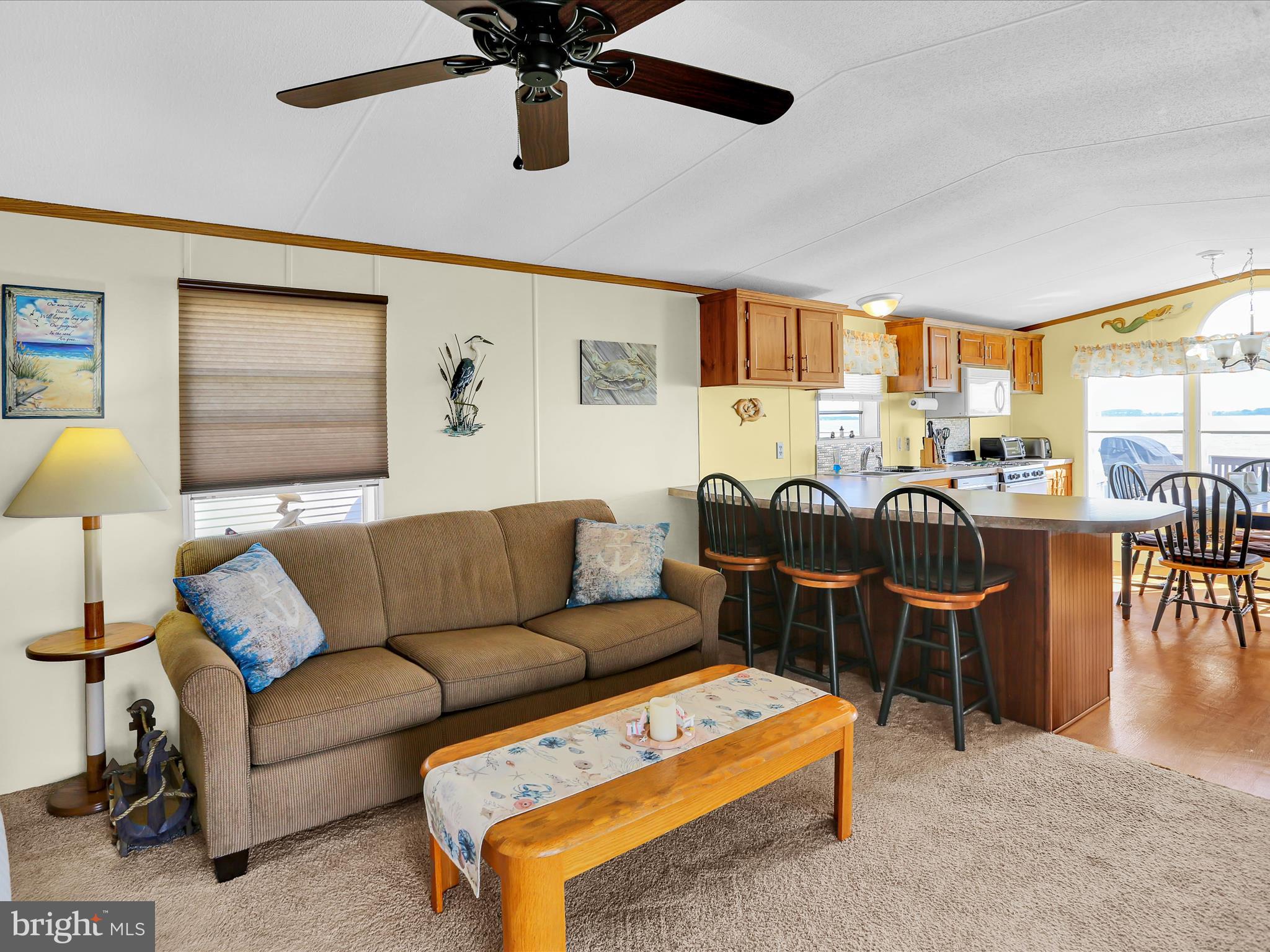 27412 Grove Circle Road Millsboro, DE 19966 - Photo 15 of 43 a living room with furniture a flat screen tv and a large window