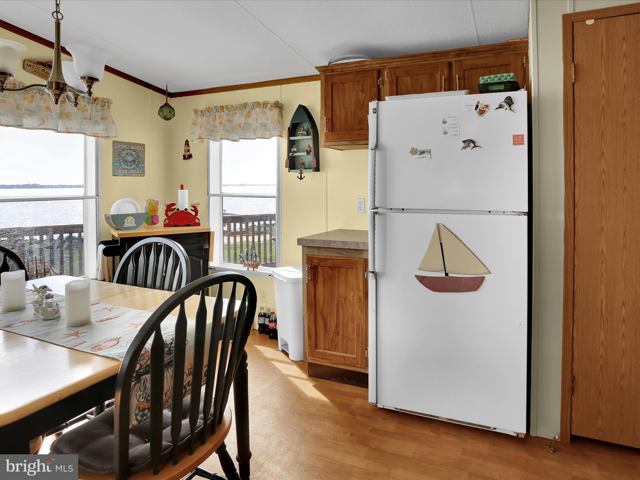 27412 Grove Circle Road Millsboro, DE 19966 - Photo 19 of 43 a view of a dining room with furniture window and wooden floor