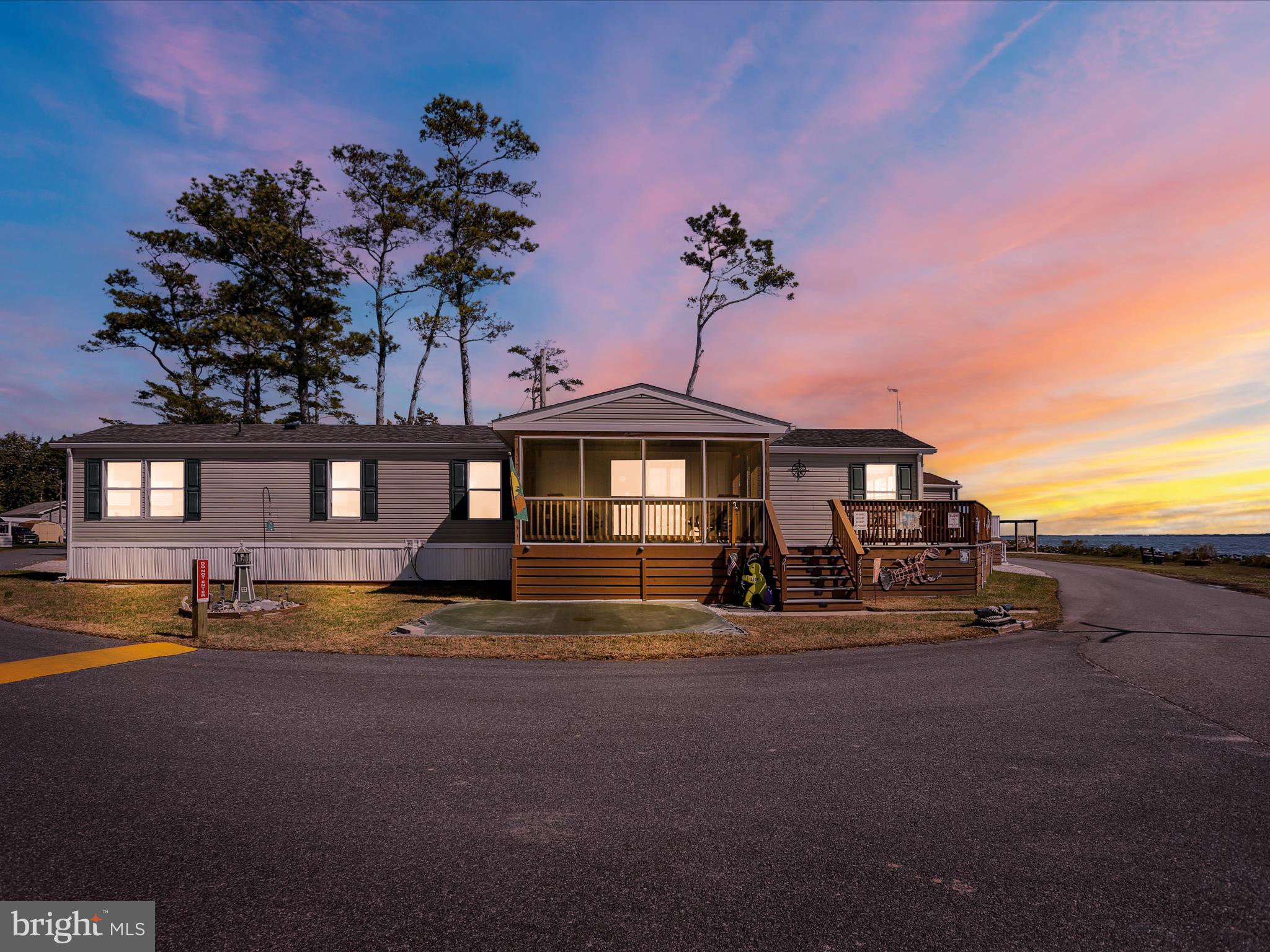 27412 Grove Circle Road Millsboro, DE 19966 - Photo 2 of 43 a front view of a house with swimming pool and porch