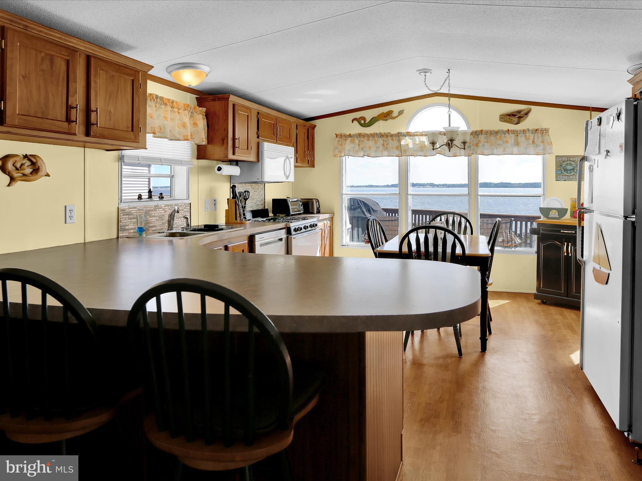 27412 Grove Circle Road Millsboro, DE 19966 - Photo 22 of 43 a kitchen with sink dining table and chairs