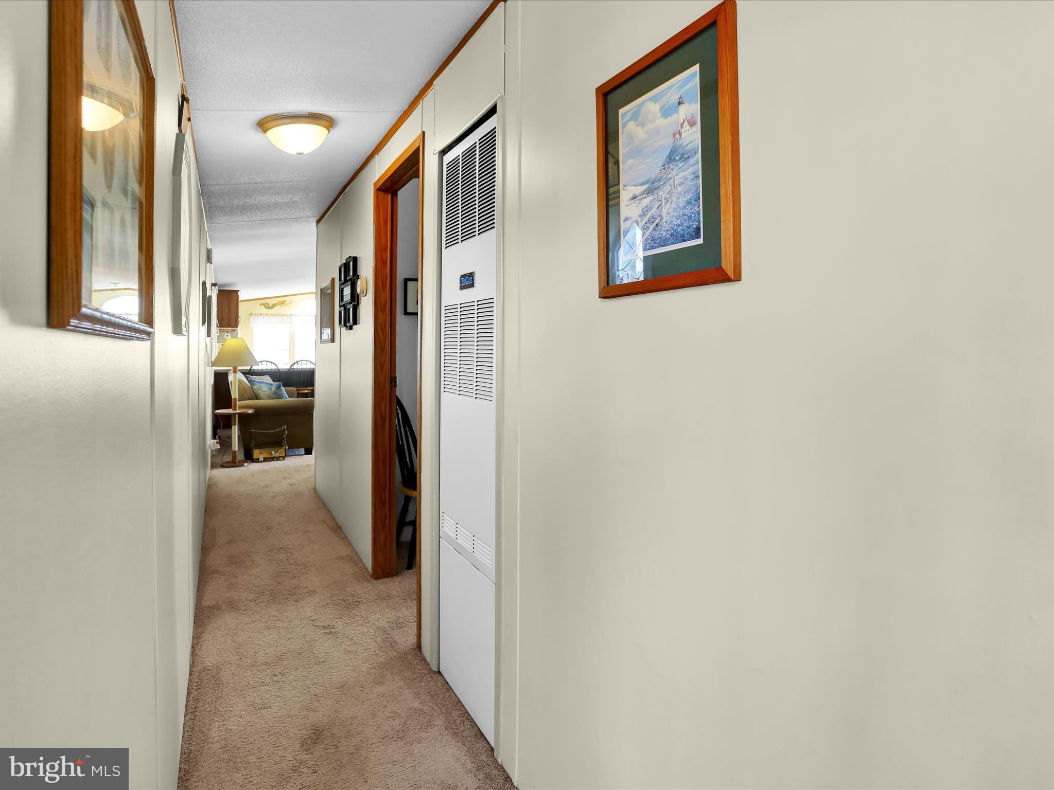 27412 Grove Circle Road Millsboro, DE 19966 - Photo 34 of 43 a view of a hallway with wooden shelves