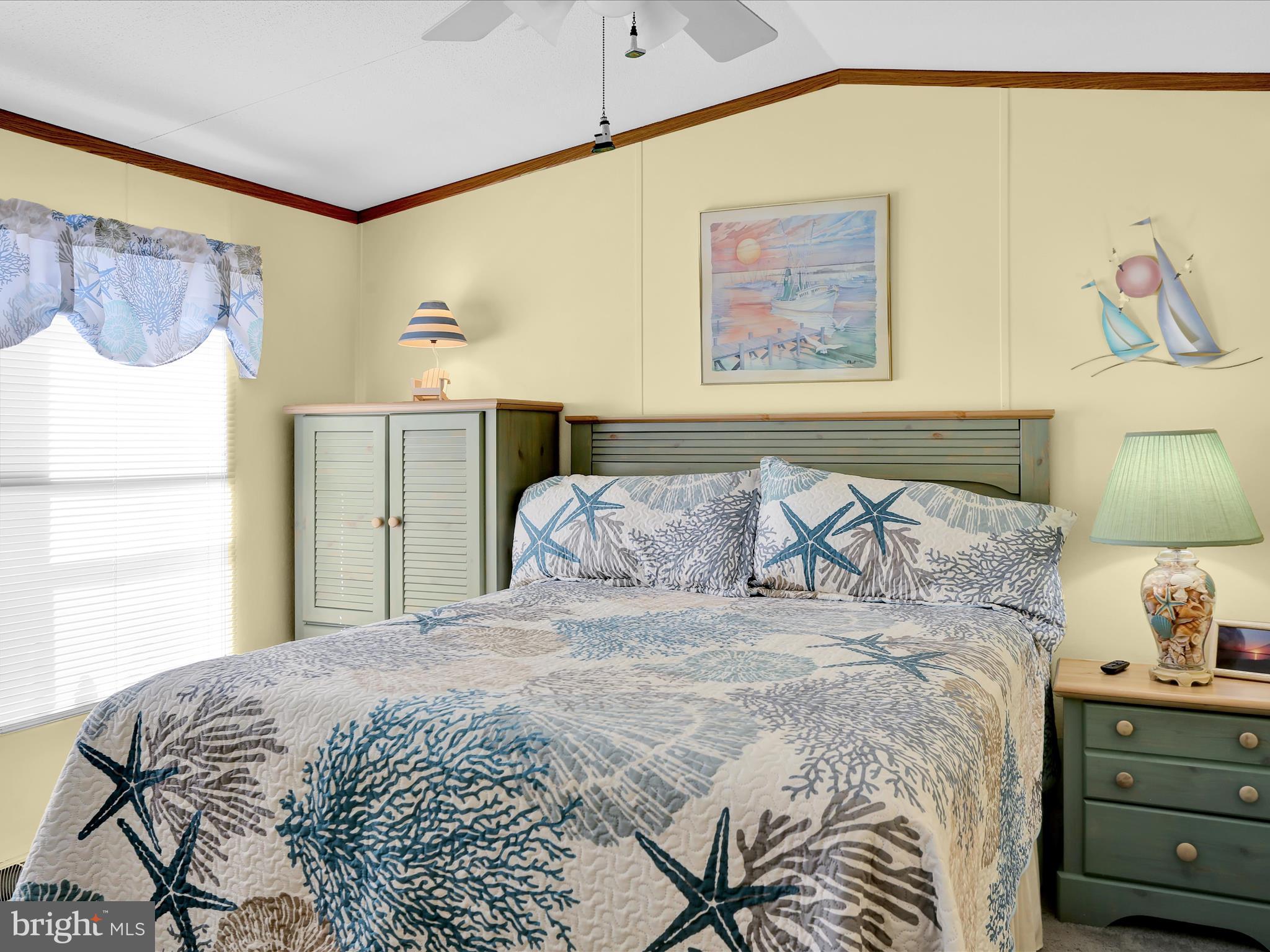 27412 Grove Circle Road Millsboro, DE 19966 - Photo 38 of 43 a bedroom with a bed and a painting on the wall