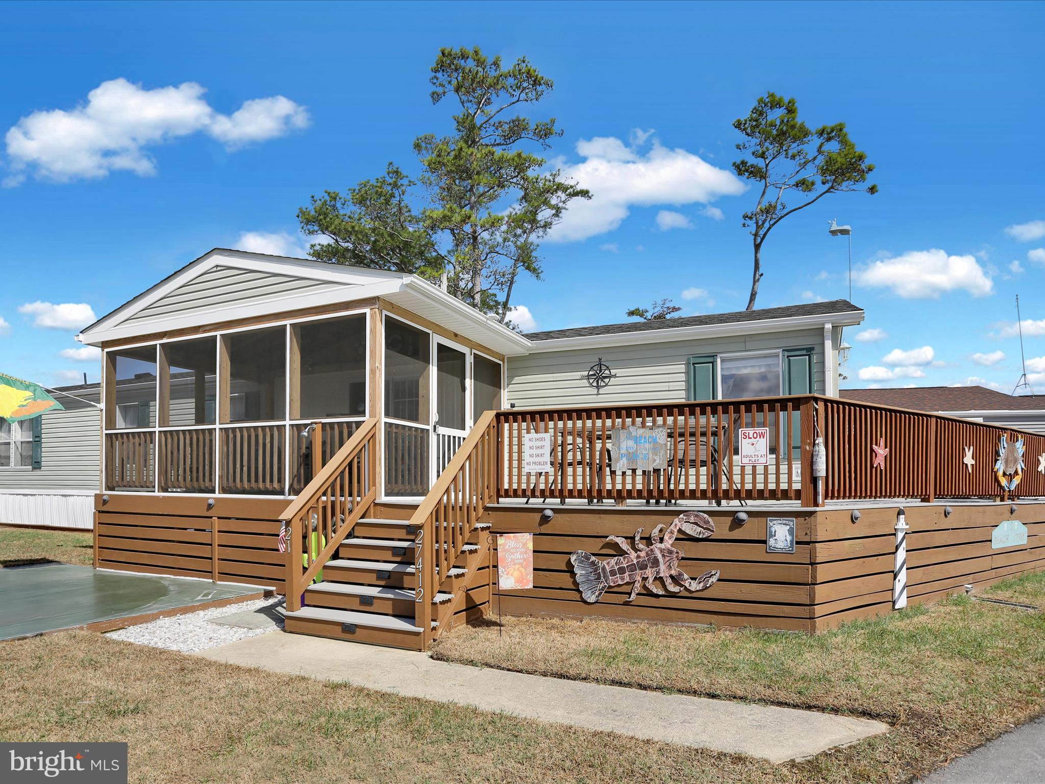 27412 Grove Circle Road Millsboro, DE 19966 - Photo 9 of 43 a front view of a house with a garden