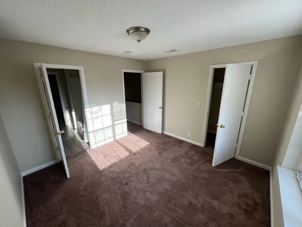 a view of entryway with window and wooden floor