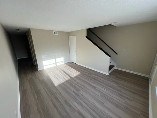 wooden floor in an empty room with a window